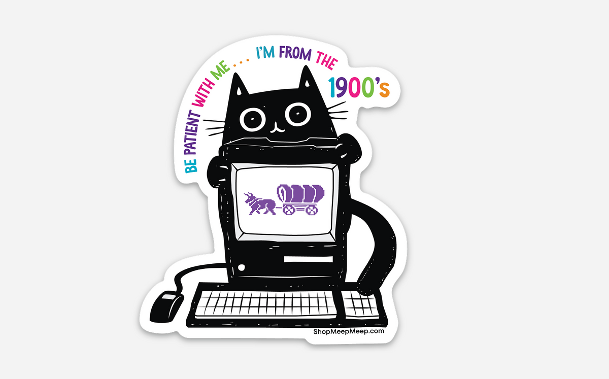 Vinyl Sticker with a black cat using an old computer, text 'Be patient with me... I'm From the 1900's" computer screen has a pixelated image of an ox pulling a covered wagon which looks similar to the Oregon Trail game.