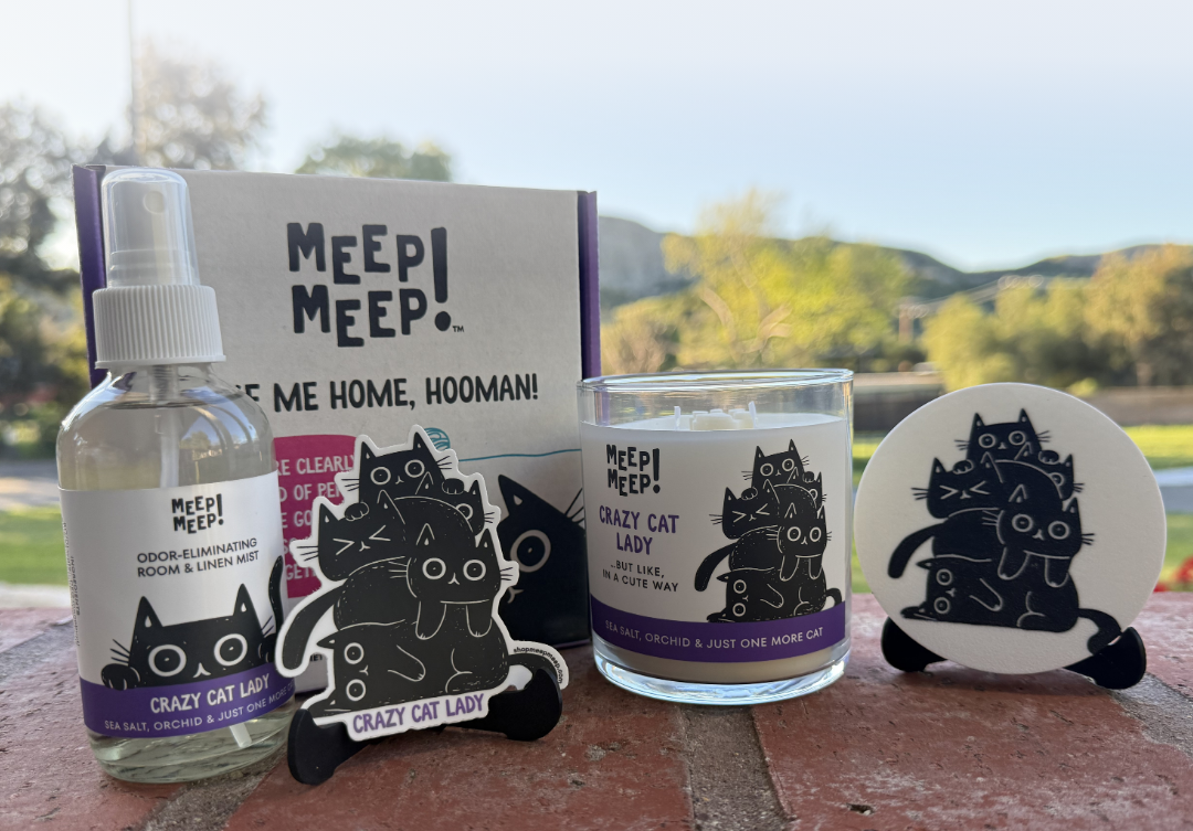 Crazy Cat Lady candle gift set with room spray, sticker, candle, candle lid & gift box displayed all featuring the Meep Meep black cats. 