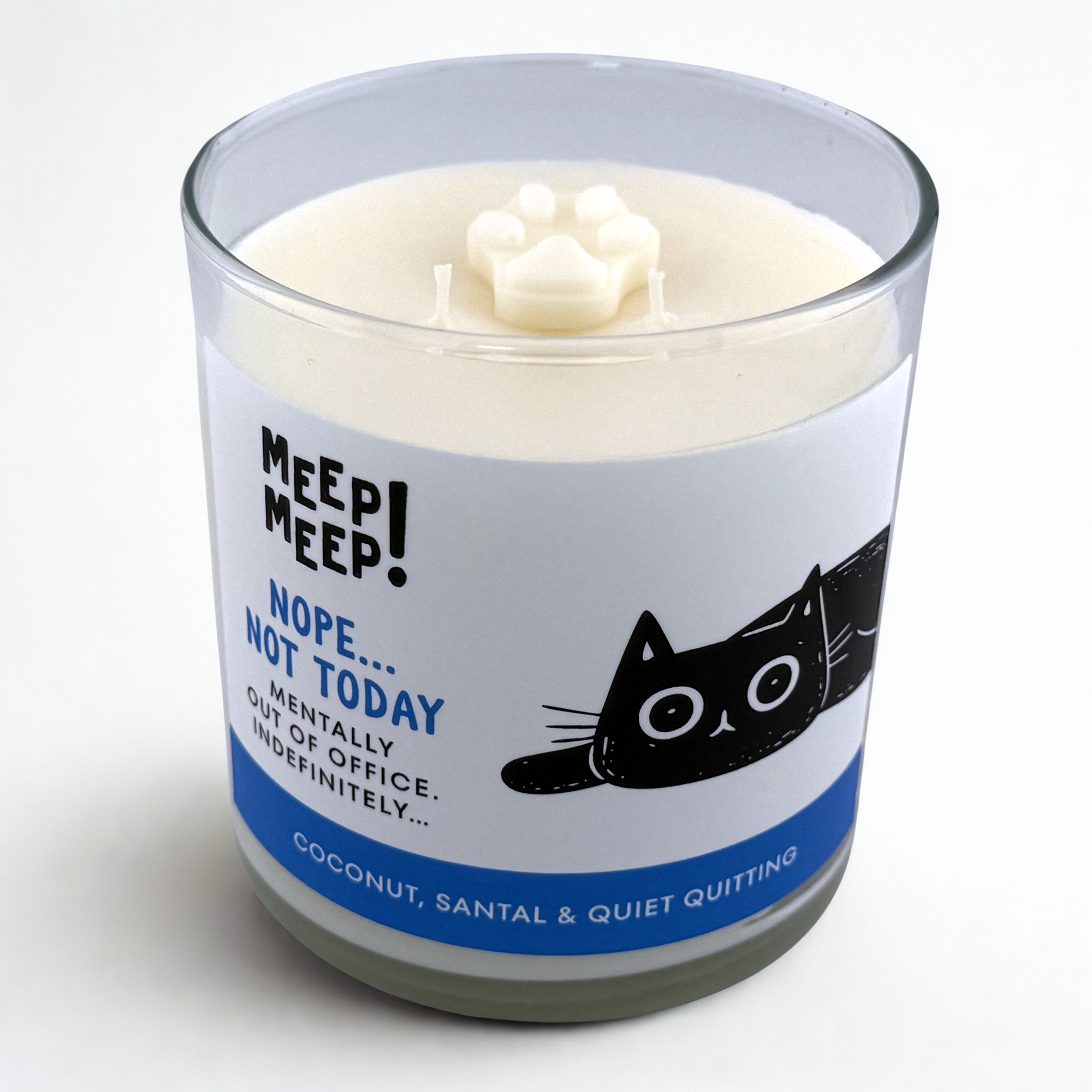 Photograph of Meep Meep candle with wax paw print embed on top. Label has an Illustration of a black cat laying spread out on floor. Text on white background says "nope...not today. Mentally out of OFfice.Indefinitely..."
Bottom of candle label reads coconut, santal & Quiet Quitting
