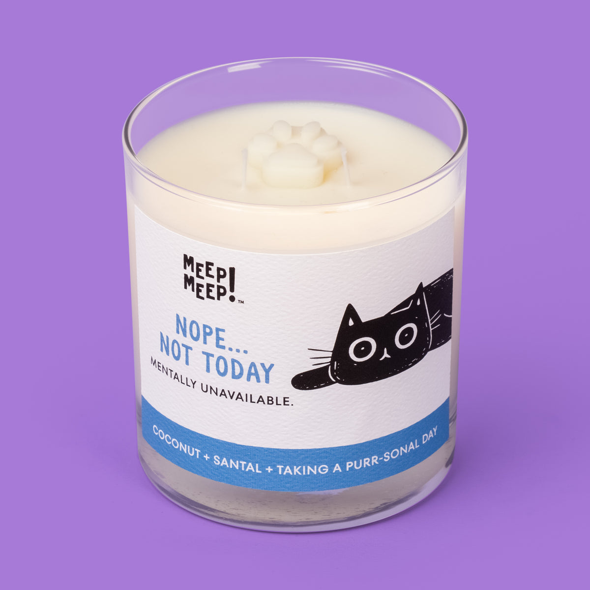 Meep Meep Nope Not Today candle in a clear glass jar with a blue-accented label featuring a lounging black cat. Jar is angled so we can see the paw embed on top of candle.
