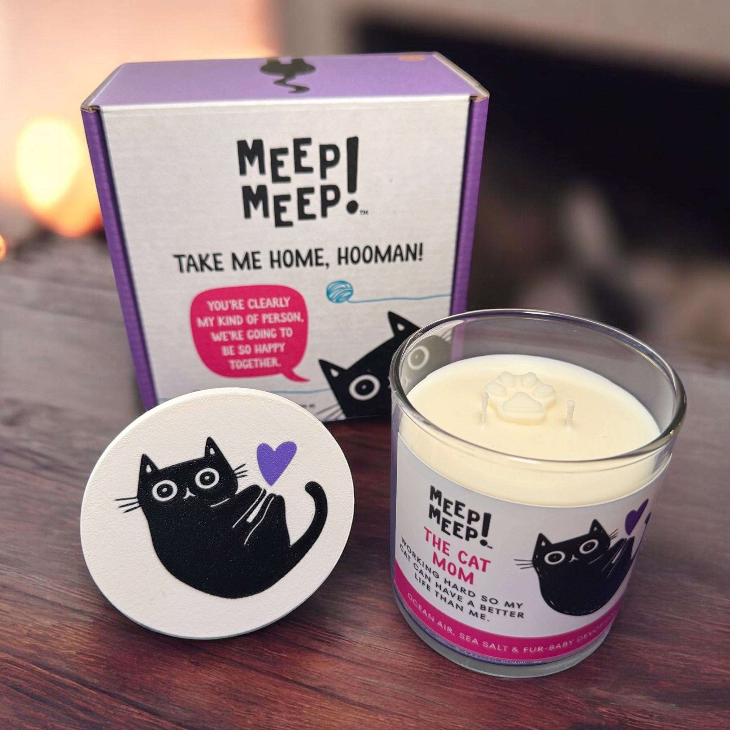 Cat mom candle gift set with black cat design, olive oil wax candle in glass jar, paw print wax top, and Meep Meep branded gift box for cat lovers. Every gift box comes with a stand to hold the lid while burning. 