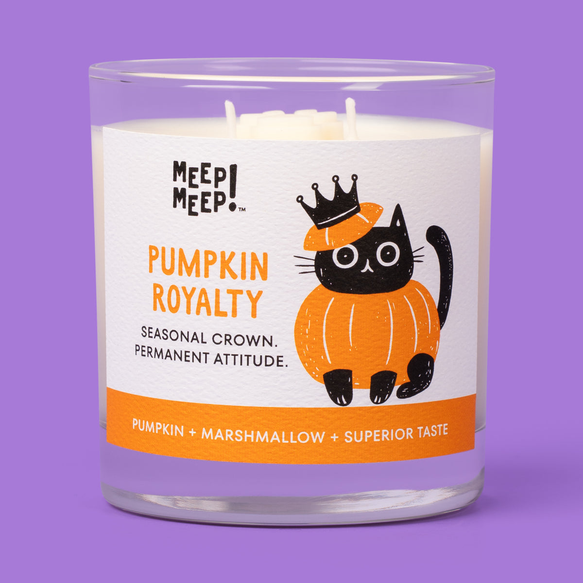 Meep Meep Pumpkin Royalty candle in a clear glass jar with a label showing a black cat in a pumpkin costume and crown.